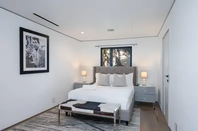a white bedroom with a bed and a window at Sunset Plaza Ultra Modern Home in Los Angeles