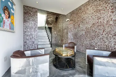 a living room with two chairs and a table at Sunset Plaza Ultra Modern Home in Los Angeles
