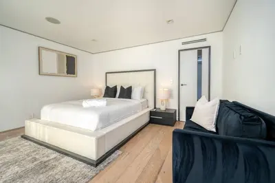 a white bedroom with a bed and a couch at Sunset Plaza Ultra Modern Home in Los Angeles