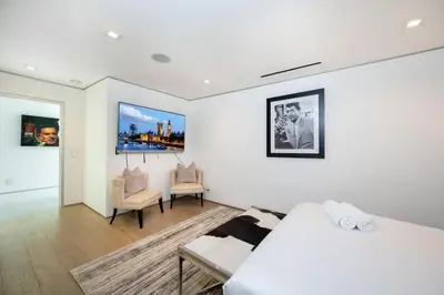 a bedroom with a bed and a living room at Sunset Plaza Ultra Modern Home in Los Angeles