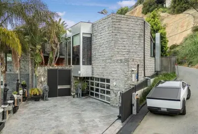 a car parked in front of a brick house at Bali Inspired Villa in Sunset Plaza in Los Angeles