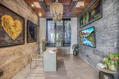 a living room with a table and a wall at Bali Inspired Villa in Sunset Plaza in Los Angeles