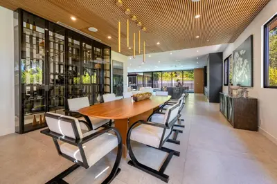 a dining room with a wooden table and chairs at Luxury 6BR Beverly Hills Villa with Pool and Views in Los Angeles
