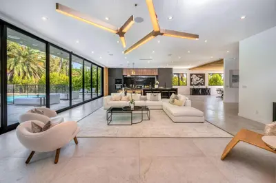 a living room with white furniture and large windows at Luxury 6BR Beverly Hills Villa with Pool and Views in Los Angeles