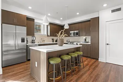a kitchen with a large island with bar stools at Sapphire Marina - Marina View Pool, Gym, Game Room in Los Angeles