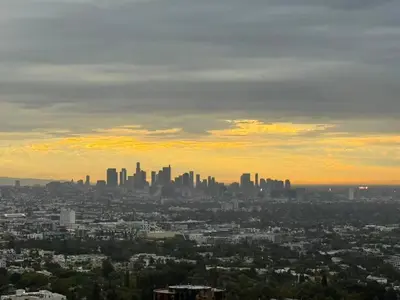 a view of a city skyline at sunset at Serene Glasshouse Retreat with Iconic LA Skyline Views in Los Angeles