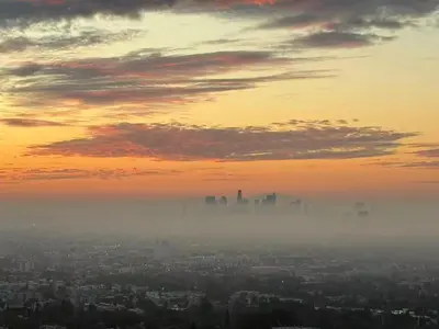 a view of a city in the fog at sunset at Hollywood Hills Glass Cabin-Skyline view -Floor to Ceiling Windows in Los Angeles