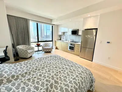 a large bedroom with a bed and a kitchen at DTLA Luxury Studio in Los Angeles
