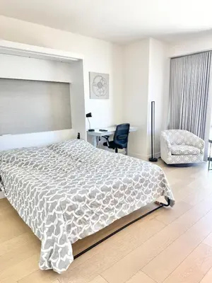 a bedroom with a bed and a desk and a chair at DTLA Luxury Studio in Los Angeles