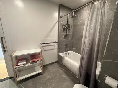 a bathroom with a shower and a tub and a sink at DTLA Luxury Studio in Los Angeles