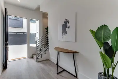 a hallway with a staircase and a wooden stool at Luxury Modern 4 Bed 4 Bath Home with Rooftop Deck #6 in Los Angeles
