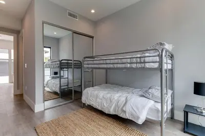 a bedroom with two bunk beds and a mirror at Luxury Modern 4 Bed 4 Bath Home with Rooftop Deck #6 in Los Angeles