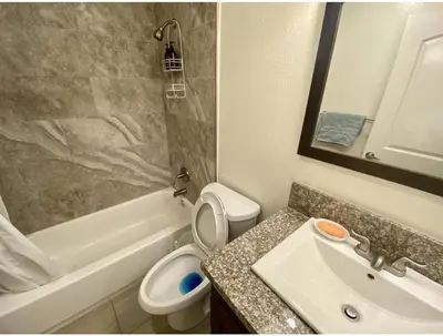 a bathroom with a sink and a toilet and a bath tub at Bunk beds in Los Angeles