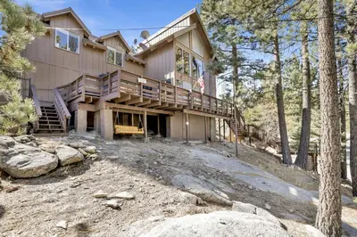 a house on a hill in the woods at Round Rock Lodge at Big Bear Boulder Bay Modern Retreat w/ Pool Table Minutes to Activities in Big Bear Lake
