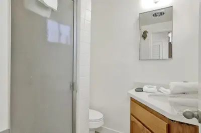 a bathroom with a shower and a toilet and a sink at Round Rock Lodge at Big Bear Boulder Bay Modern Retreat w/ Pool Table Minutes to Activities in Big Bear Lake