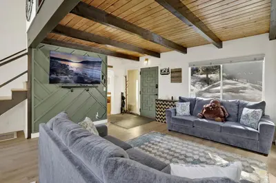 a living room with two couches and a tv at Round Rock Lodge at Big Bear Boulder Bay Modern Retreat w/ Pool Table Minutes to Activities in Big Bear Lake