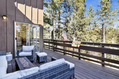 a patio with a couch and chairs on a deck at Round Rock Lodge at Big Bear Boulder Bay Modern Retreat w/ Pool Table Minutes to Activities in Big Bear Lake