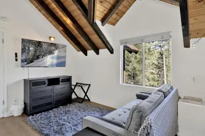 a living room with a couch and a tv at Round Rock Lodge at Big Bear Boulder Bay Modern Retreat w/ Pool Table Minutes to Activities in Big Bear Lake