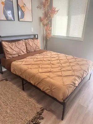 a large bed in a bedroom with a vase at Cozy Studio, Studio City Unit 2 in Los Angeles