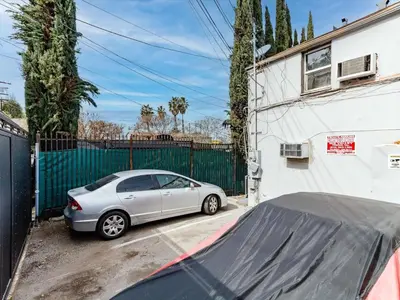 a silver car parked in front of a fence at Cozy Studio, Studio City Unit 2 in Los Angeles