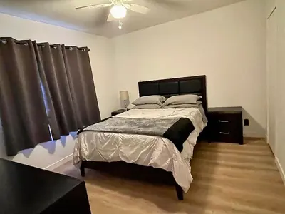 a bedroom with a bed and a ceiling fan at SMA Apartment in Los Angeles