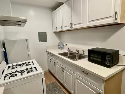 a kitchen with a stove and a sink and a microwave at SMA Apartment in Los Angeles