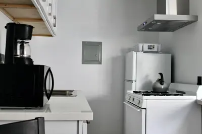 a kitchen with a white stove and a white refrigerator at SMA Apartment in Los Angeles