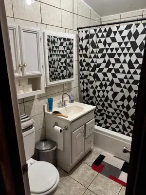 a bathroom with a sink and a toilet and a shower at Cozy Private Room Near Disneyland, Beaches & Downtown LA in Artesia