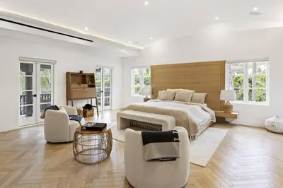 a white bedroom with a large bed and chairs at One of Kind Ultra Luxury Beverly Hills Estate in Los Angeles