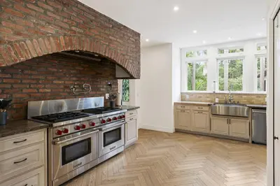 a kitchen with an oven and a brick wall at One of Kind Ultra Luxury Beverly Hills Estate in Los Angeles