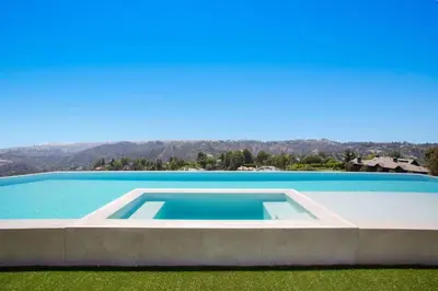 a large swimming pool in the middle of a yard at Ultra-Luxurious BH Estate with Pool, Theatre, Views in Beverly Hills