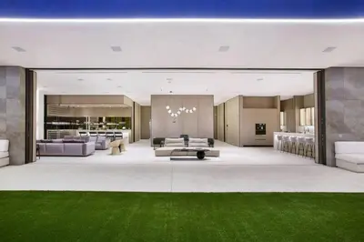 a large living room with green grass in the middle at Ultra-Luxurious BH Estate with Pool, Theatre, Views in Beverly Hills