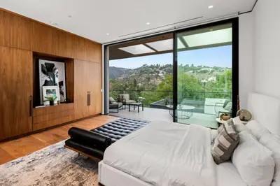 a bedroom with a large bed and a large window at Luxurious 5BR Villa in BH with Pool, Theater, and Views in Los Angeles