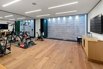 a gym with treadmills and exercise equipment in a room at Luxurious 5BR Villa in BH with Pool, Theater, and Views in Los Angeles