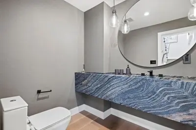 a bathroom with a sink and a mirror and a toilet at Luxury Jupiter Estate with 4BR with Pool and Jacuzzi in Los Angeles