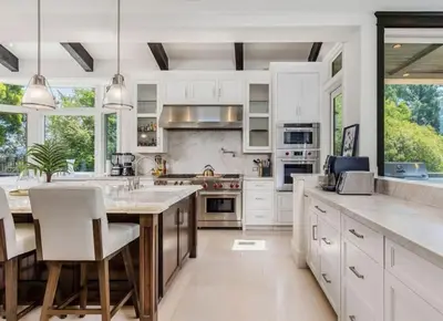 a kitchen with white cabinets and a large island at Summitridge Bev Hills Villa with Pool, Spa, Roof Deck in Beverly Hills
