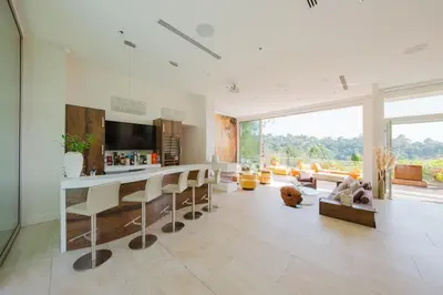 a living room with a bar and a large window at Beverly Hills Ultra Luxury Villa with Pool and Theatre in Beverly Hills