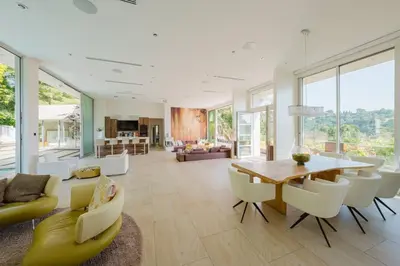 a living room with a wooden table and chairs at Beverly Hills Ultra Luxury Villa with Pool and Theatre in Beverly Hills