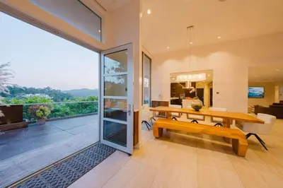 a dining room with a table and a bench at Beverly Hills Ultra Luxury Villa with Pool and Theatre in Beverly Hills