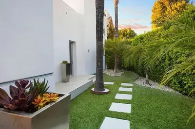 a garden with green grass and a pathway at Beverly Hills Mansion W. Stunning Views in Beverly Hills