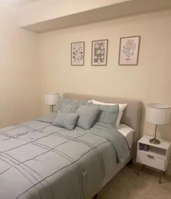 a bedroom with a large bed with two lamps on it at Holiday in LA- Koreatown Retreat with Free Parking, Pool and Sauna in Los Angeles