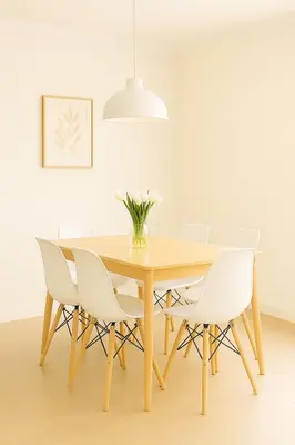 a dining room table with white chairs and a vase of flowers at Holiday in LA- Koreatown Retreat with Free Parking, Pool and Sauna in Los Angeles