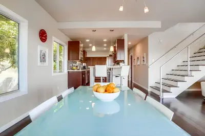 a dining room with a glass table and a bowl of fruit at LA Chic Stunning Views & Sunsets in Los Angeles