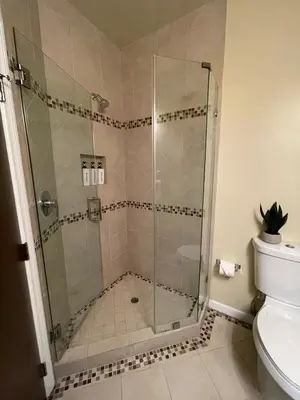 a shower with a glass door in a bathroom at LA Chic Stunning Views & Sunsets in Los Angeles