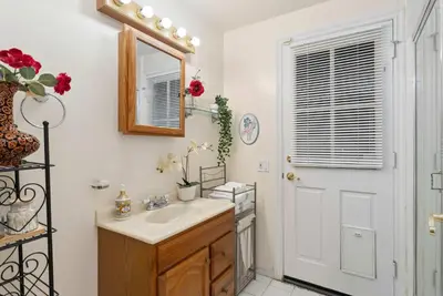 a bathroom with a sink and a mirror at Luxury LA Garden Estate Private Pool HotTub Tennis in La Habra