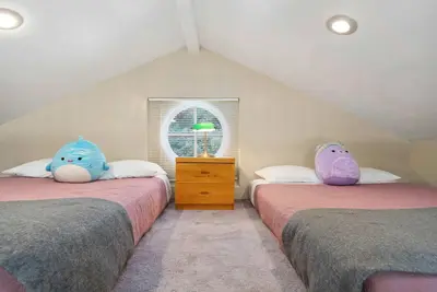 two beds with stuffed animals on them in a attic at Luxury LA Garden Estate Private Pool HotTub Tennis in La Habra