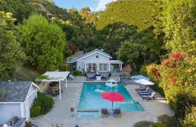 an aerial view of a swimming pool with a house at Luxury LA Garden Estate Private Pool HotTub Tennis in La Habra