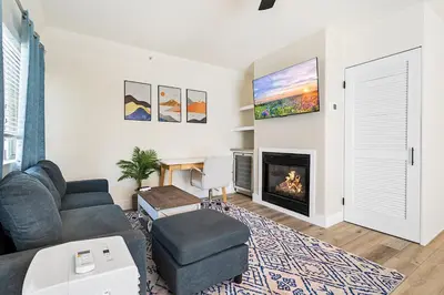 a living room with a couch and a fireplace at Charming Modern apartment in Santa Monica in Los Angeles