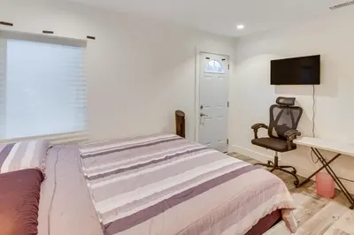 a bedroom with a bed and a desk and a chair at Work and Play! North Hills Studio 15 Mi to Hollywood in North Hills