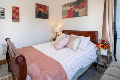 a bedroom with a bed with white sheets and pillows at Sleek Studio Near Downtown LA • AC • WiFi • Snacks in Los Angeles